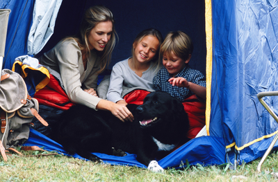 Family in a tent with a dog